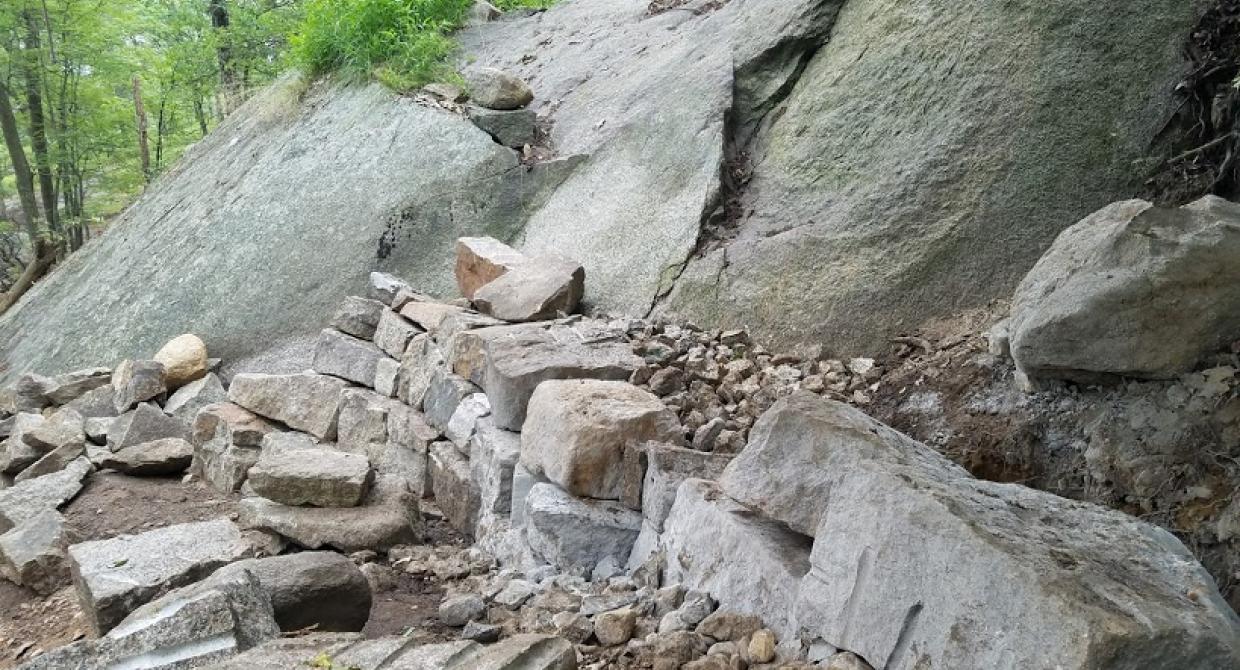 The Megalithic Trail Crew is building a crib wall staircase as part of the Appalachian Trail reroute on Bear Mountain. Photo by Eduardo Gill.